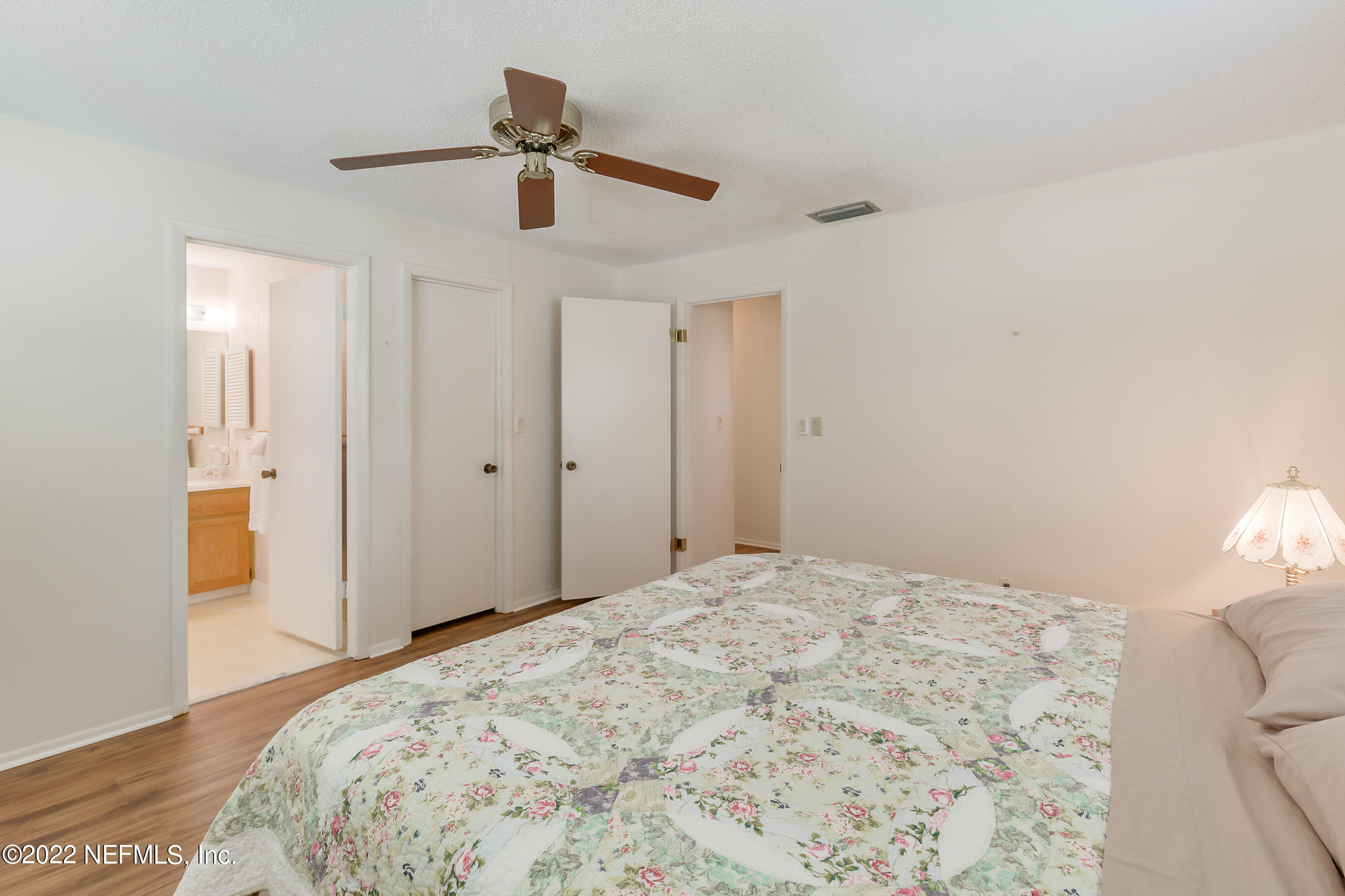 224 Lily Road St. Augustine, FL 32086 - Photo 11 of 52 a bedroom with a bed and cabinets