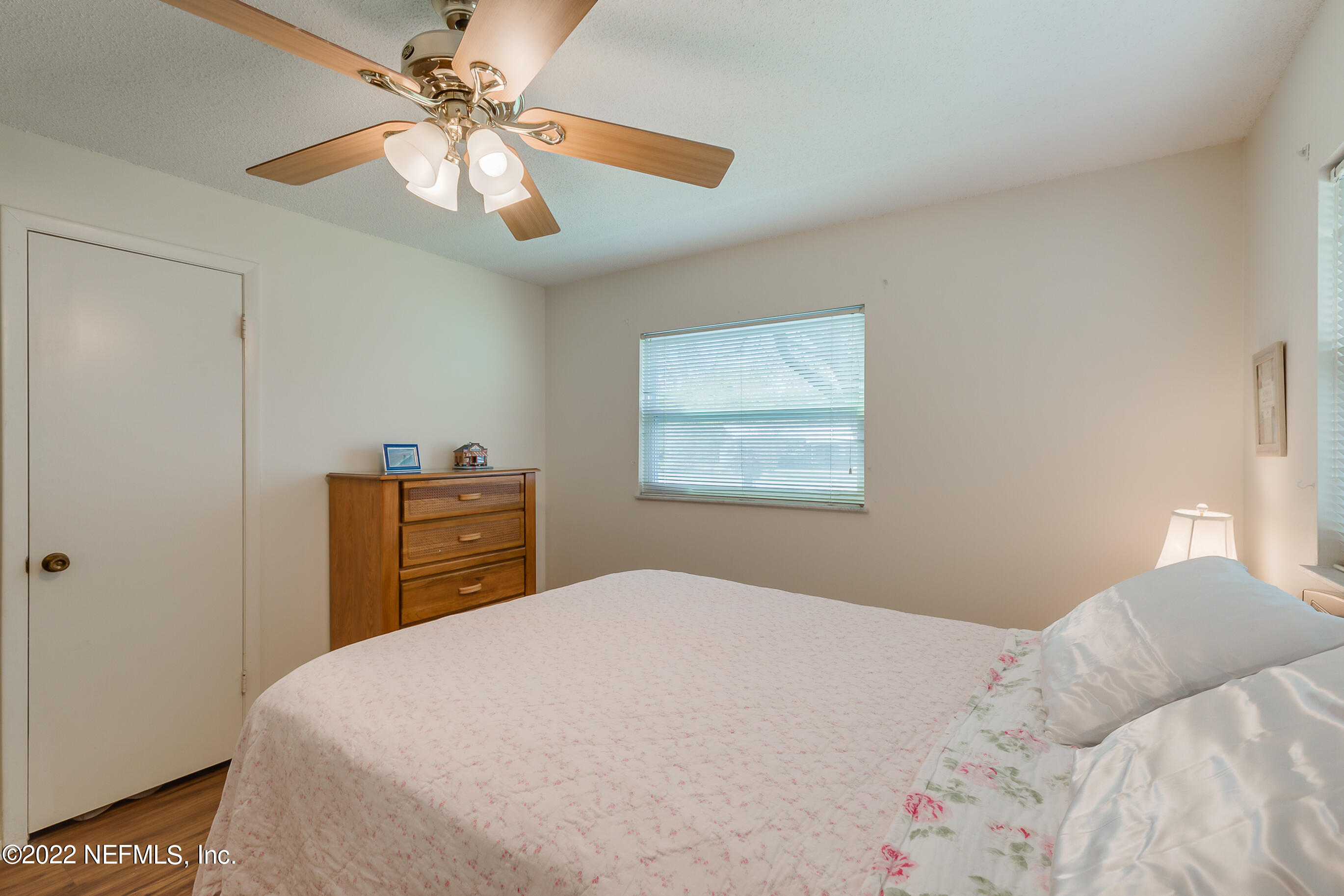 224 Lily Road St. Augustine, FL 32086 - Photo 13 of 52 a bedroom with a bed and a chandelier