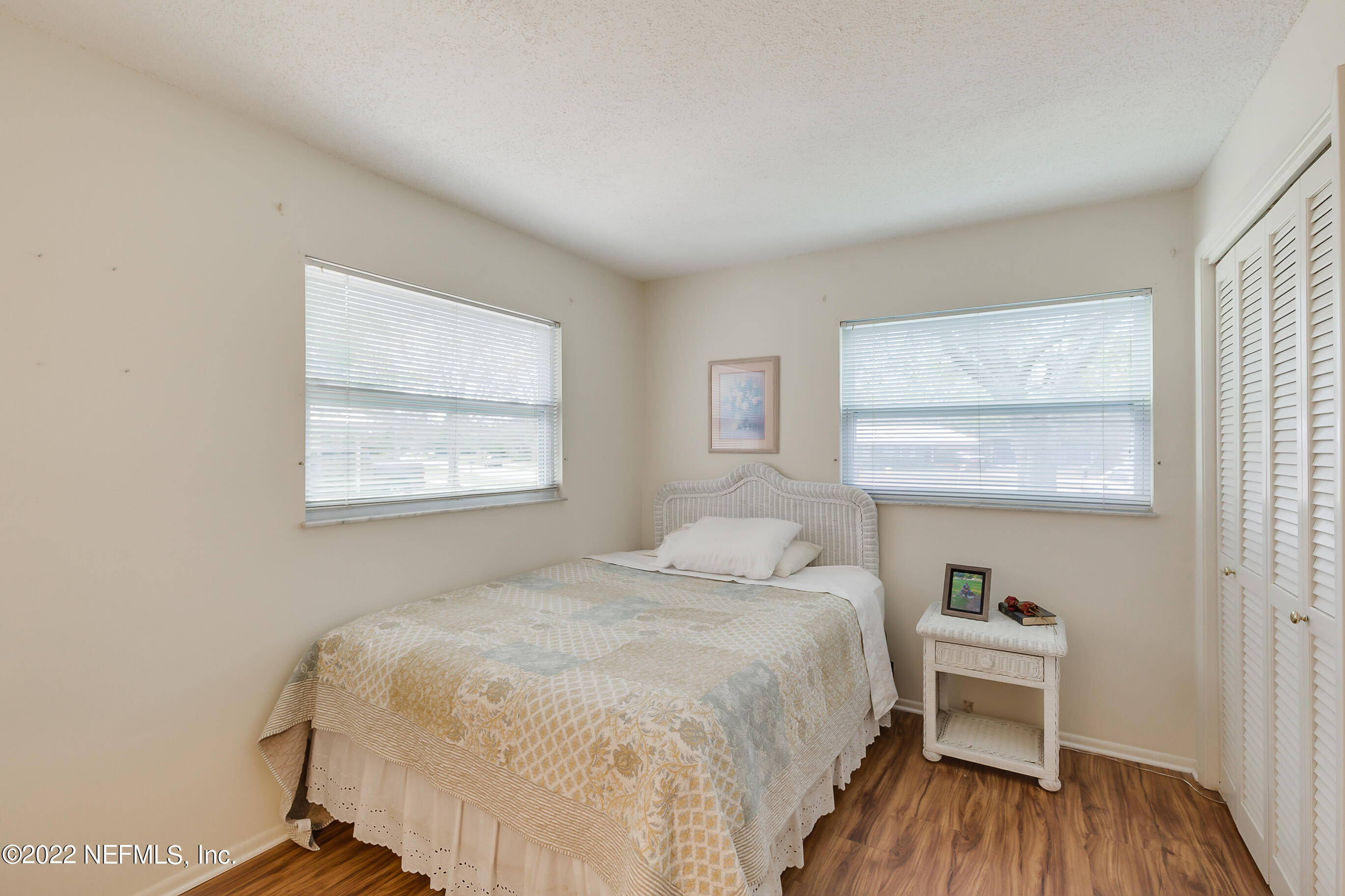 224 Lily Road St. Augustine, FL 32086 - Photo 19 of 52 a bedroom with a bed and a window