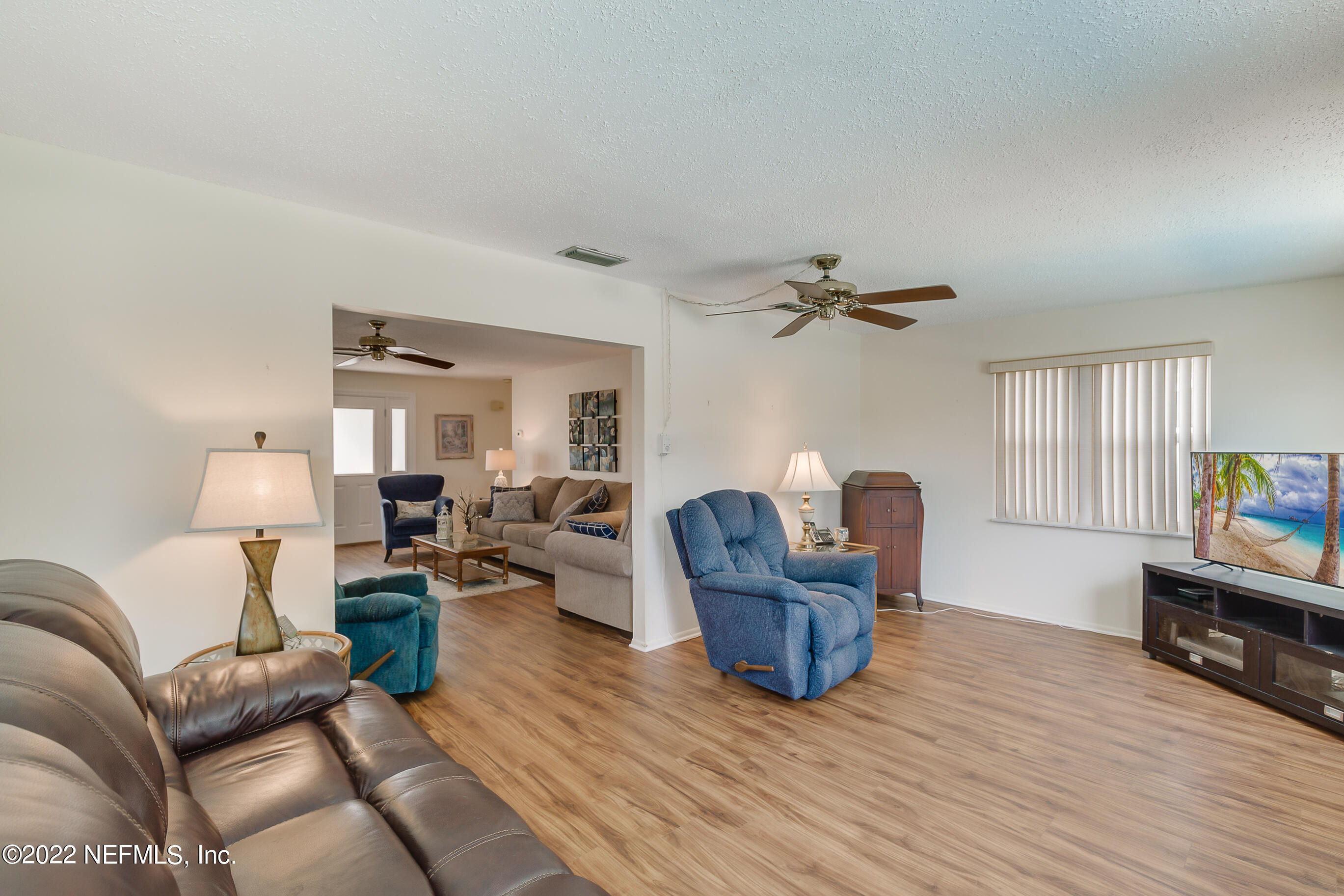 224 Lily Road St. Augustine, FL 32086 - Photo 22 of 52 a living room with furniture and a wooden floor