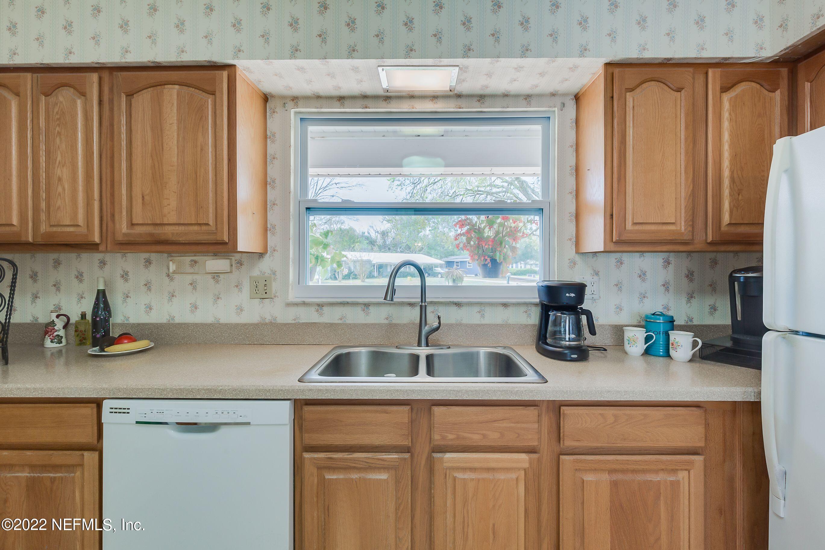 224 Lily Road St. Augustine, FL 32086 - Photo 24 of 52 a kitchen with a sink and cabinets