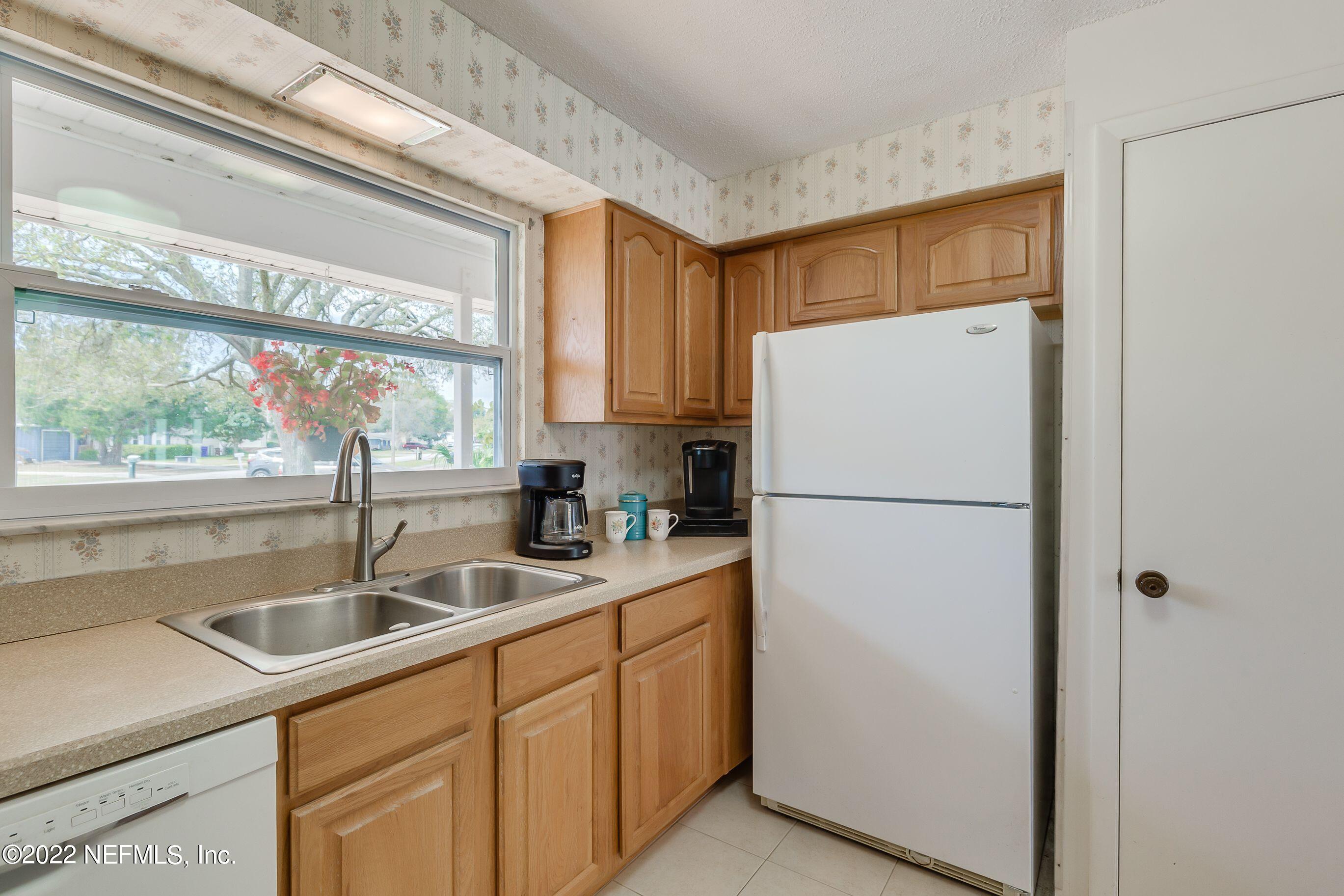 224 Lily Road St. Augustine, FL 32086 - Photo 25 of 52 a white refrigerator freezer sitting in a kitchen with a sink
