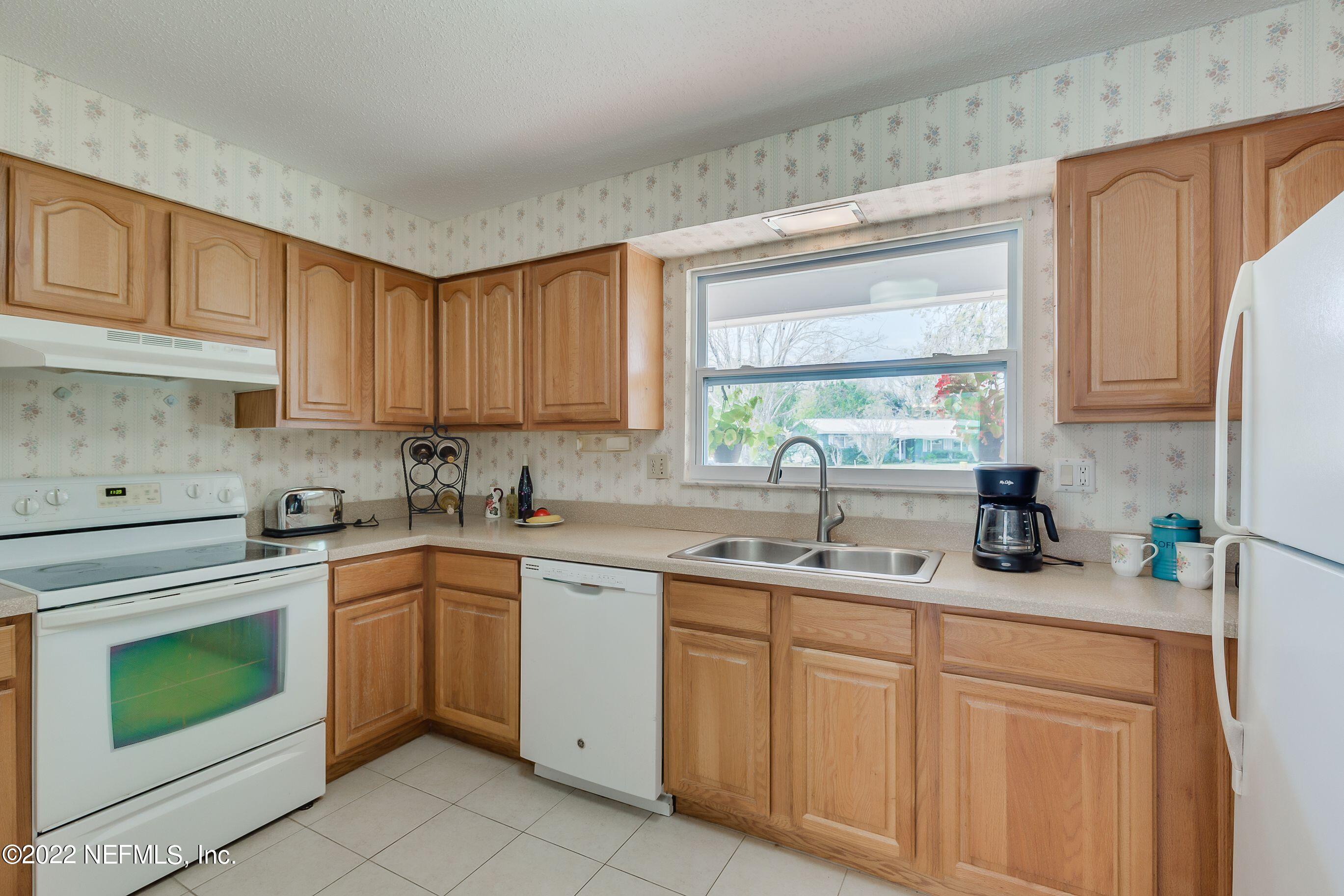 224 Lily Road St. Augustine, FL 32086 - Photo 26 of 52 a kitchen with cabinets appliances a sink and a window