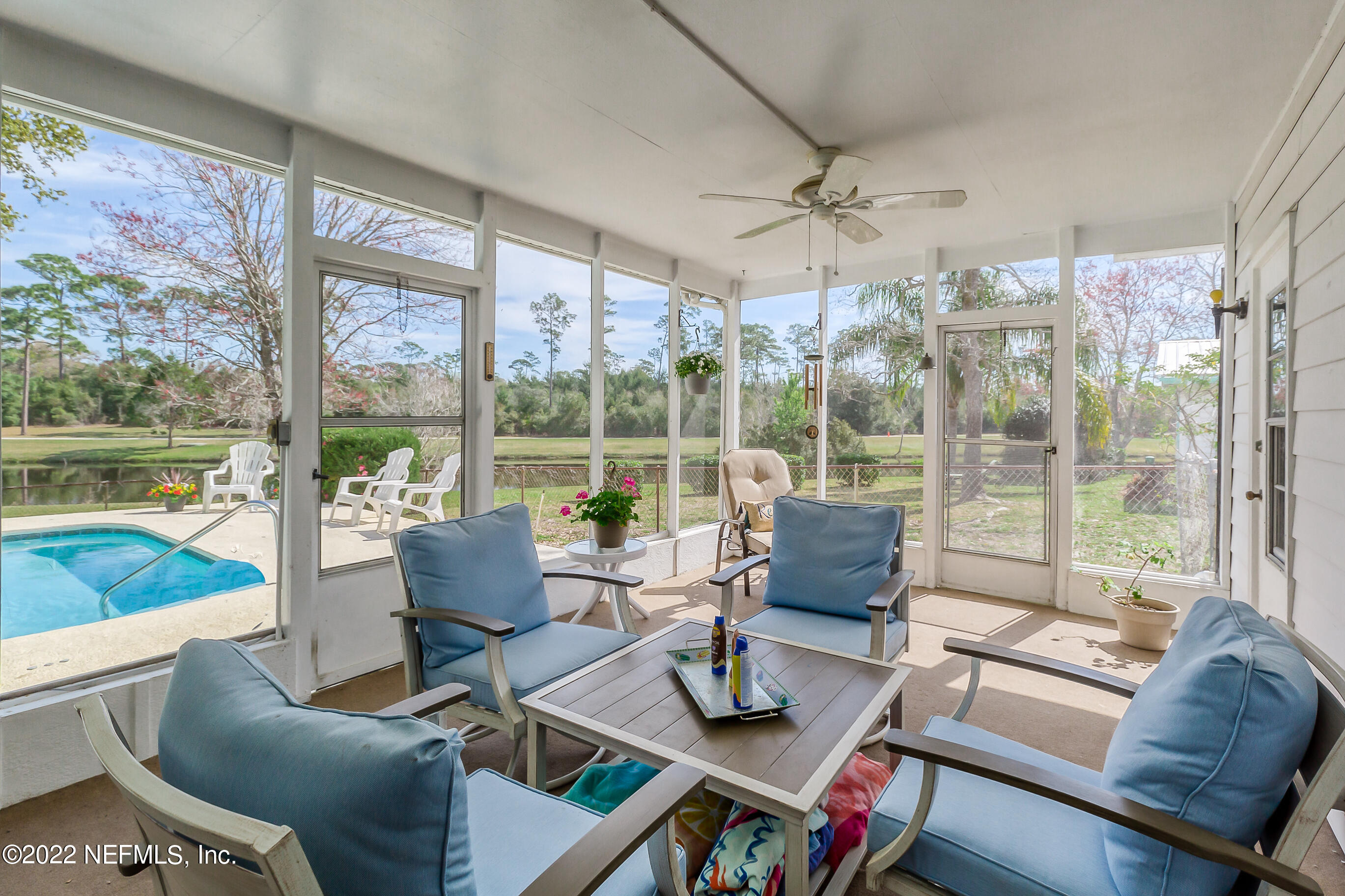 224 Lily Road St. Augustine, FL 32086 - Photo 34 of 52 a living room with furniture and a floor to ceiling window