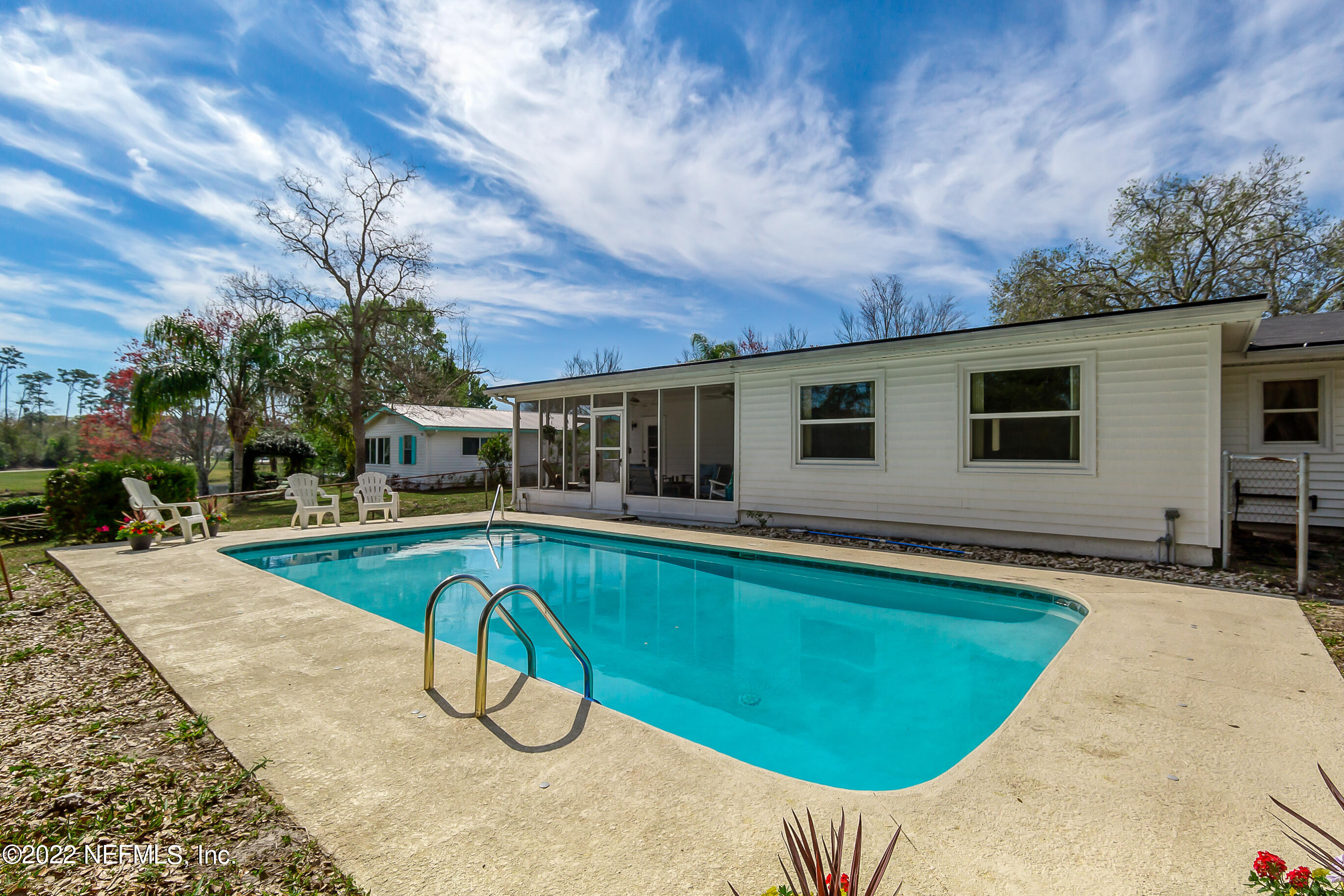 224 Lily Road St. Augustine, FL 32086 - Photo 38 of 52 a view of a house with swimming pool and sitting area