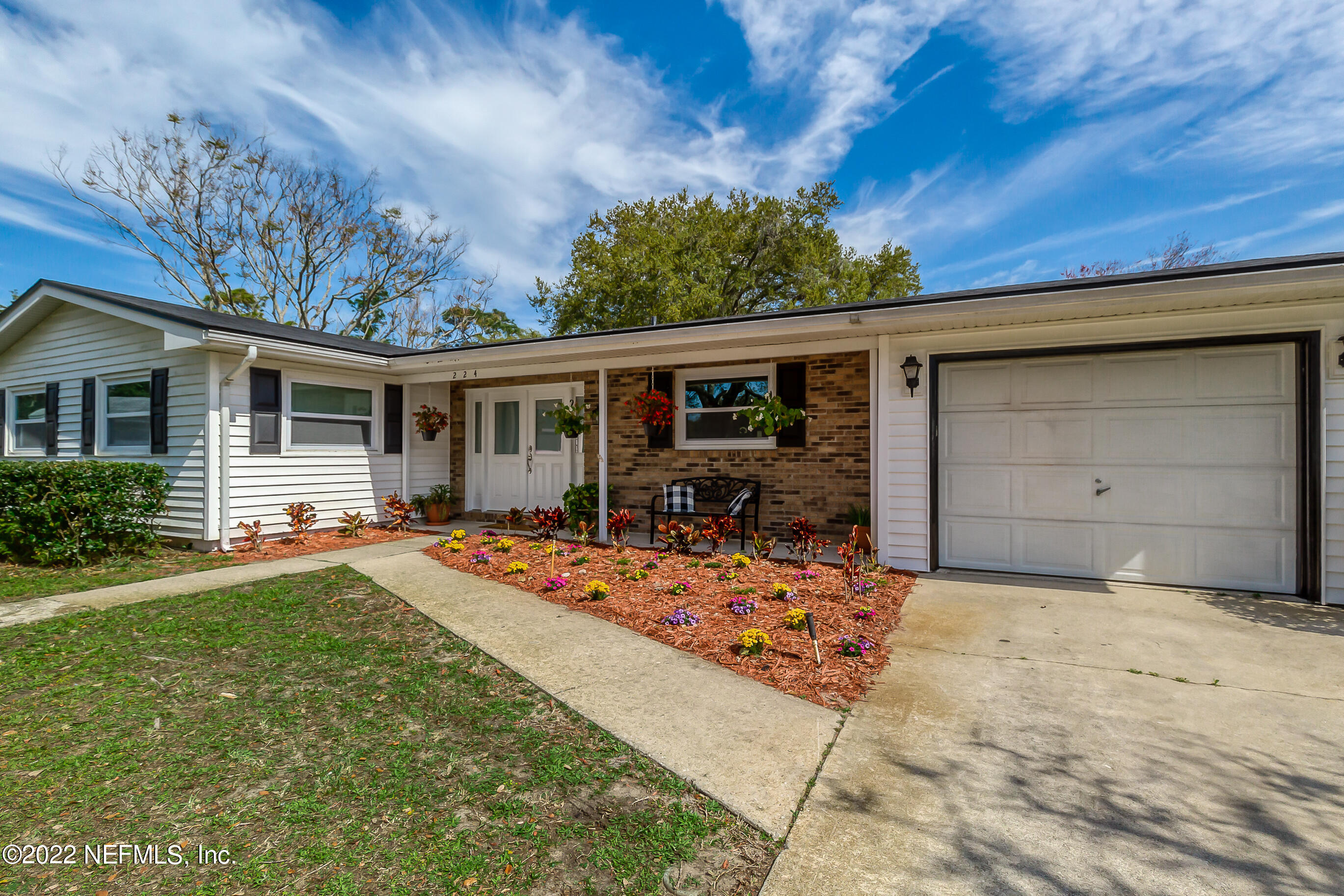 224 Lily Road St. Augustine, FL 32086 - Photo 41 of 52 a front view of a house with garden