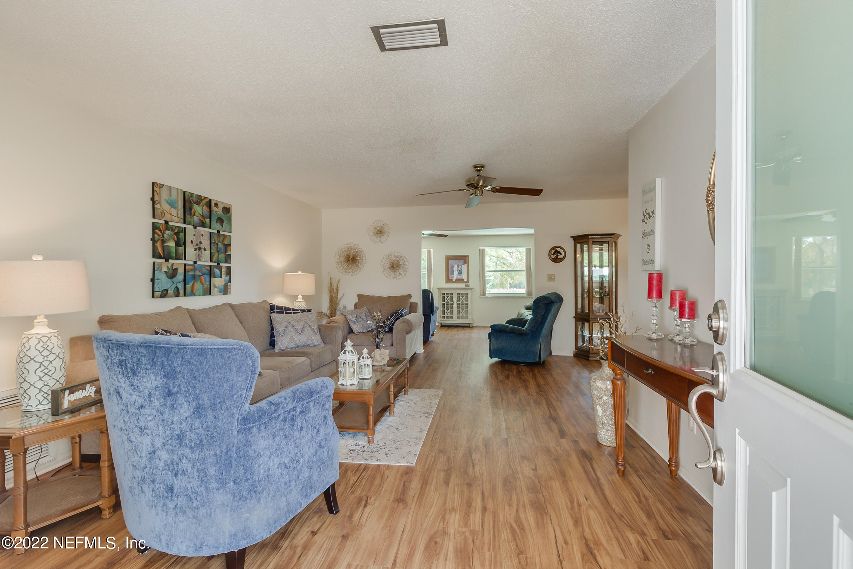 224 Lily Road St. Augustine, FL 32086 - Photo 8 of 52 a living room with furniture and a wooden floor