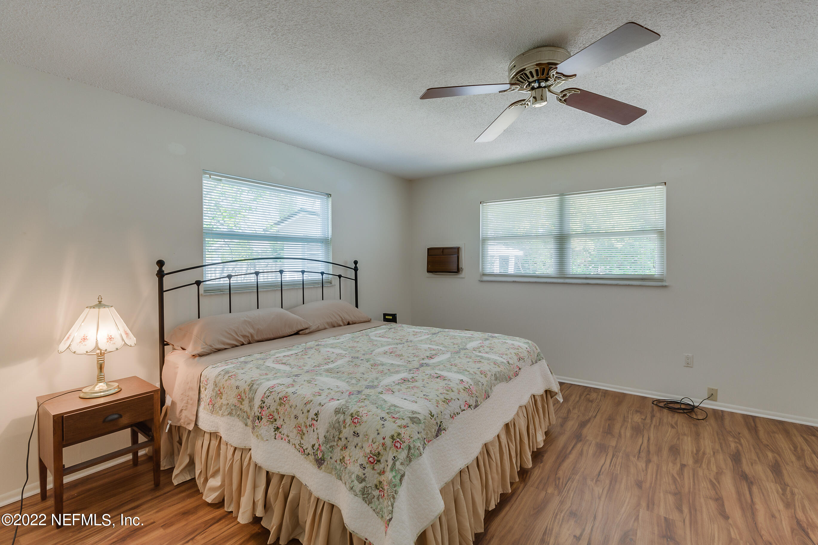 224 Lily Road St. Augustine, FL 32086 - Photo 10 of 52 a bedroom with a bed and a chandelier