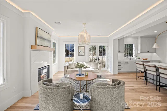 a living room with fireplace furniture and a dining table