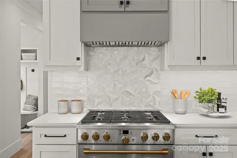 a stove top oven sitting inside of a kitchen