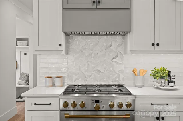 a stove top oven sitting inside of a kitchen