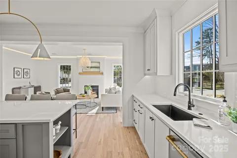 a kitchen with granite countertop a sink and wooden cabinets
