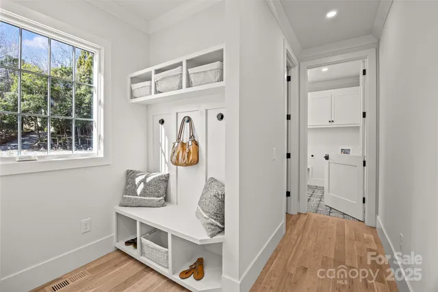 a view of an entryway with wooden floor and windows