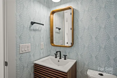 a bathroom with a sink a toilet and mirror