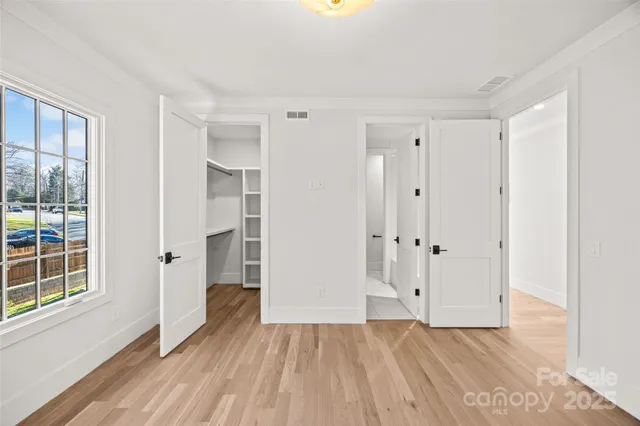a view of a room with wooden floor and windows