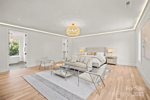 a bedroom with furniture and a wooden floor