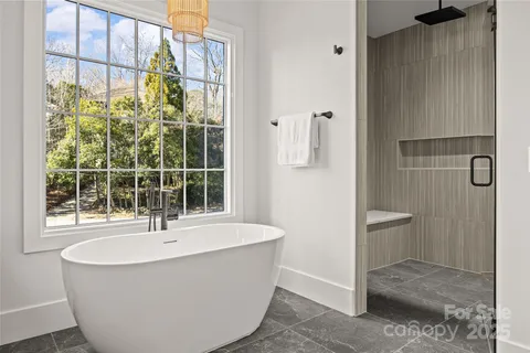 a white bath tub sitting next to a window