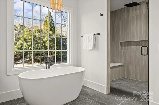 a white bath tub sitting next to a window