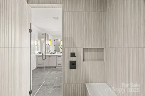 a bathroom with a double vanity sink toilet and shower