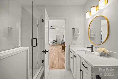 a bathroom with a double vanity sink mirror and shower