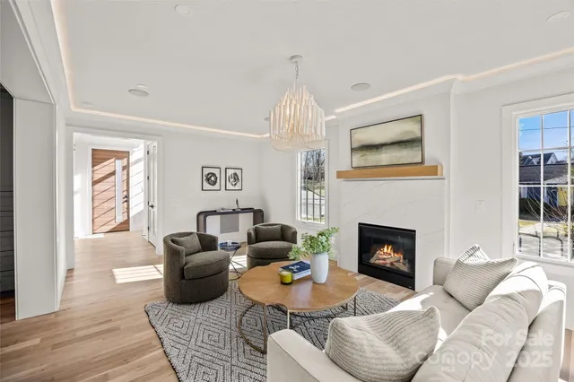 a living room with furniture a fireplace and a window