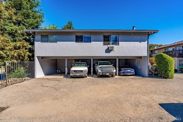 a view of house with outdoor space and parking