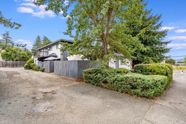 a front view of a house with a yard and a garage
