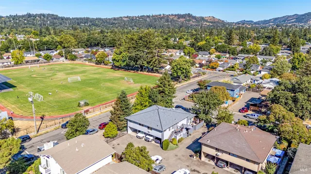 an aerial view of residential houses with outdoor space