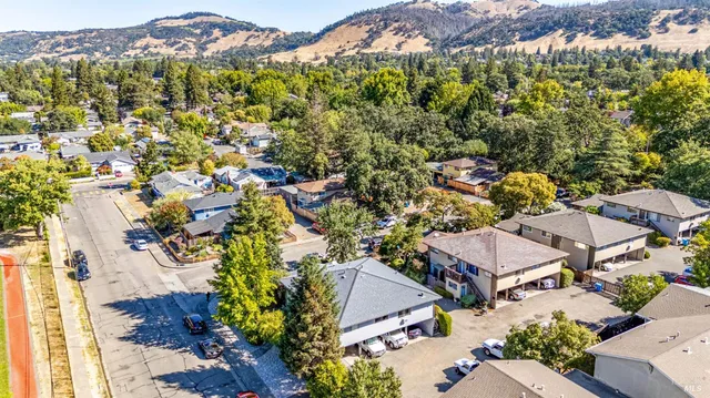 an aerial view of residential houses with outdoor space