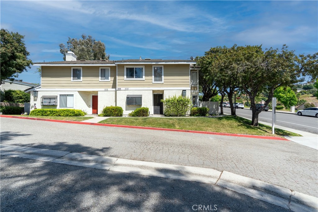 a view of road with yard and large trees