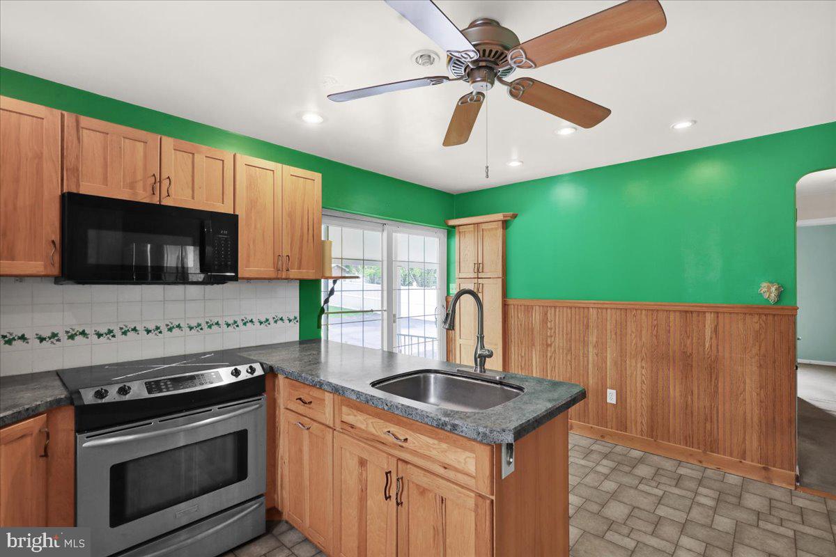 27 Woodland Road Reading, PA 19610 - Photo 10 of 34 a kitchen with kitchen island a sink stainless steel appliances and cabinets