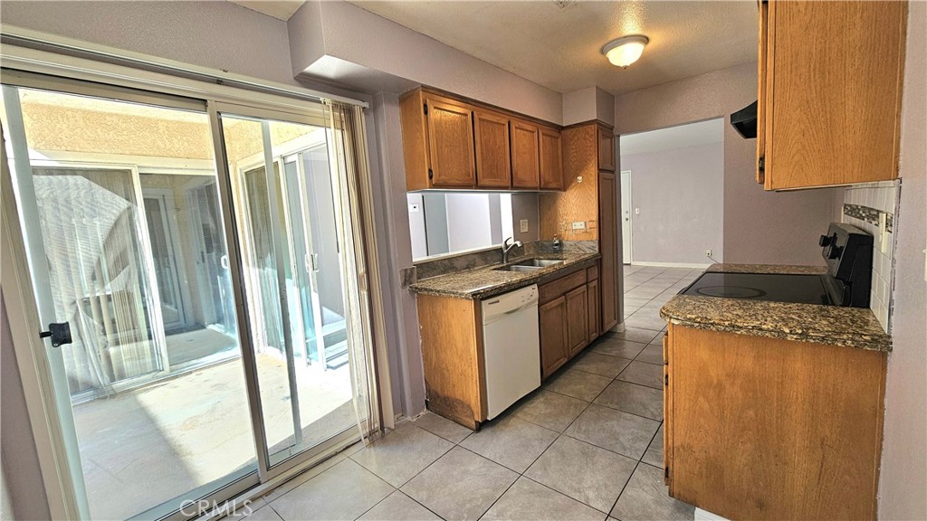 7641 Reseda Boulevard, Unit 87 Reseda, CA 91335 - Photo 15 of 37 a kitchen with granite countertop a refrigerator and a stove