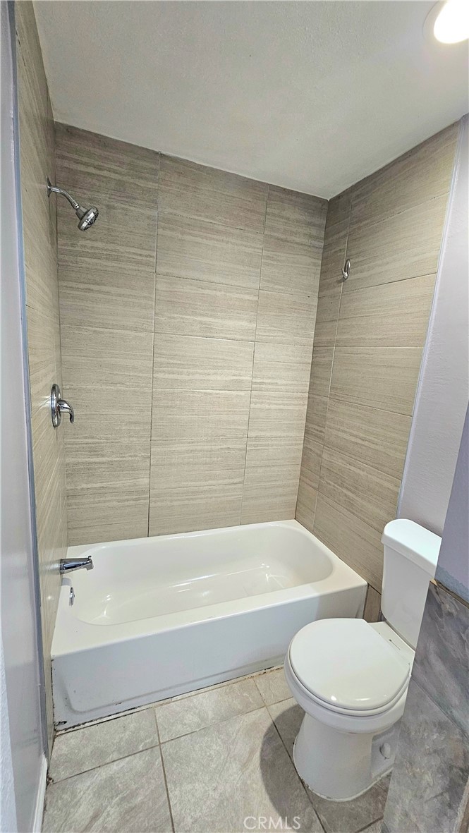 7641 Reseda Boulevard, Unit 87 Reseda, CA 91335 - Photo 19 of 37 a bathroom with a toilet and a bath tub