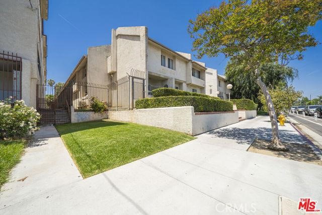 7641 Reseda Boulevard, Unit 87 Reseda, CA 91335 - Photo 2 of 37 a view of a white house with a yard