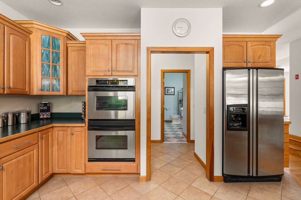 59 St Germain Road Hampden, MA 01036 - Photo 20 of 42 a kitchen with stainless steel appliances granite countertop a refrigerator and a stove top oven