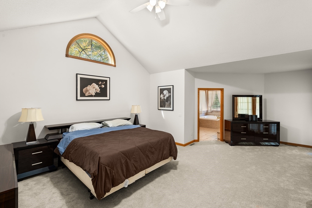 59 St Germain Road Hampden, MA 01036 - Photo 24 of 42 a spacious bedroom with a bed a couch and a window