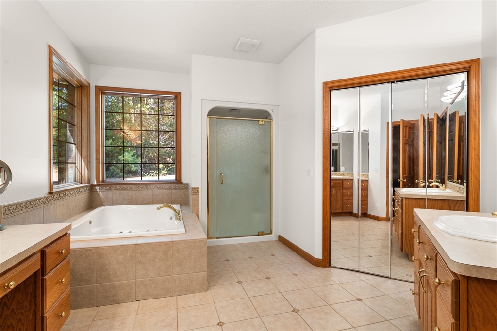 59 St Germain Road Hampden, MA 01036 - Photo 30 of 42 a bathroom with a tub a sink and a large mirror