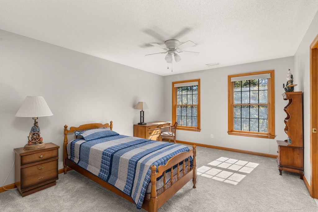 59 St Germain Road Hampden, MA 01036 - Photo 37 of 42 a bedroom with a bed and a chandelier