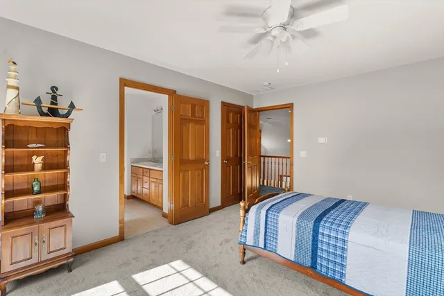 a bedroom with a bed and a ceiling fan