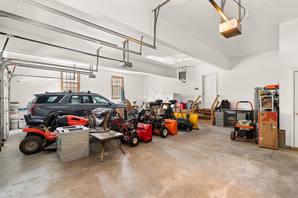 59 St Germain Road Hampden, MA 01036 - Photo 42 of 42 a view of a garage with a cars and other equipment