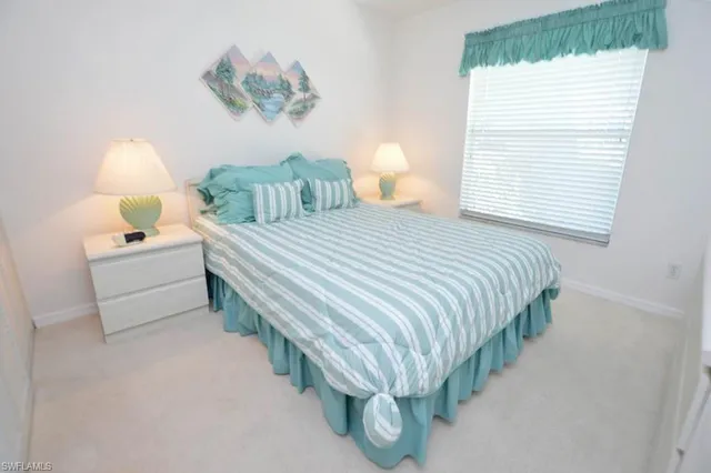 a bedroom with bed and a window