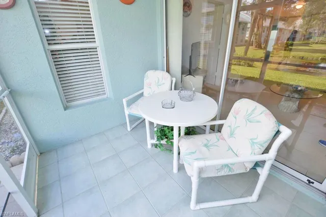 a view of a dining room with furniture and a window
