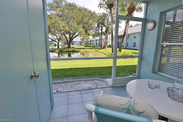 a view of a porch with furniture and garden