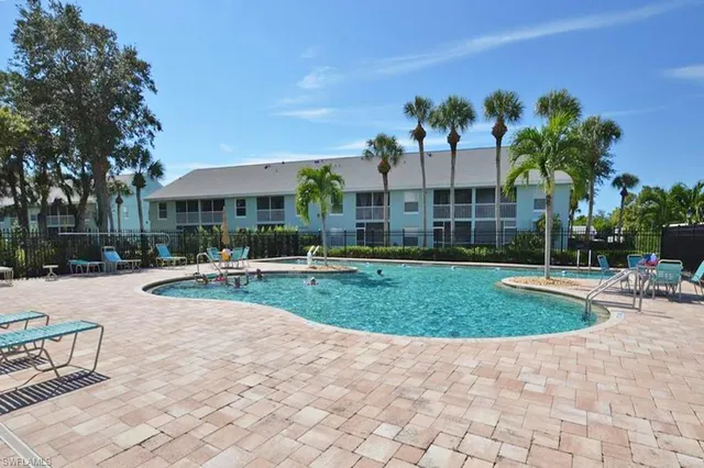 a view of a house with swimming pool and sitting area