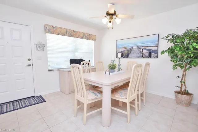 a view of a dining room with furniture and a potted plant