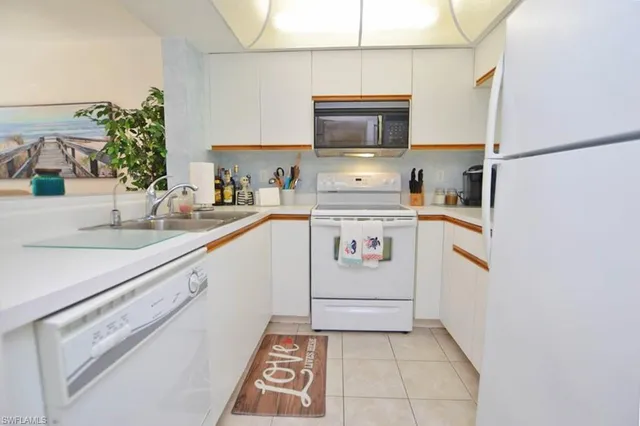 a kitchen with stainless steel appliances a sink and a stove