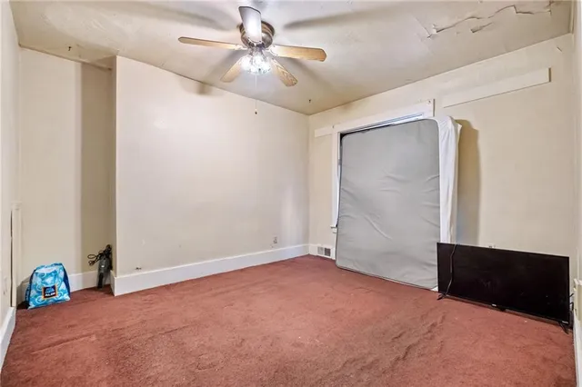 a view of a room with gym equipment and a window