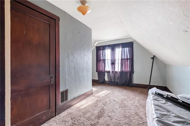 a bedroom with bed and window