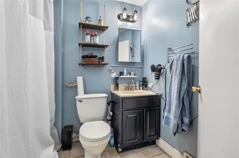 a kitchen that has a sink a stove and wooden cabinets