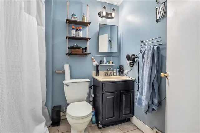 a kitchen that has a sink a stove and wooden cabinets